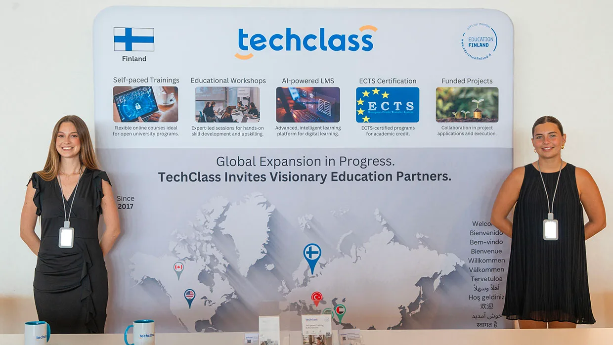 TechClass team members at a branded TechClass exhibition stand representing Finland, AI-powered LMS, since 2017