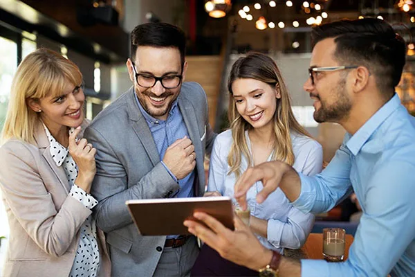 Colleagues collaborating around a tablet